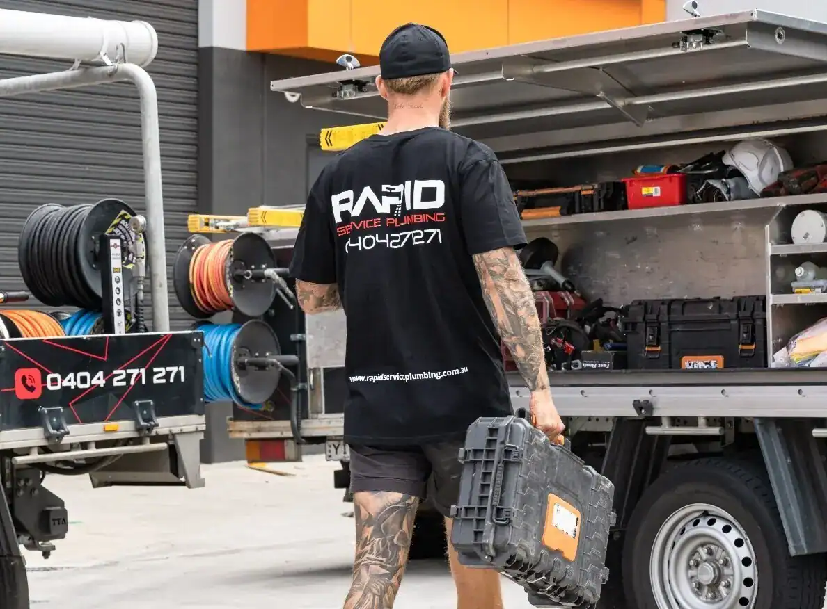 Rapid Plumbing technician unloading equipment for a repair job