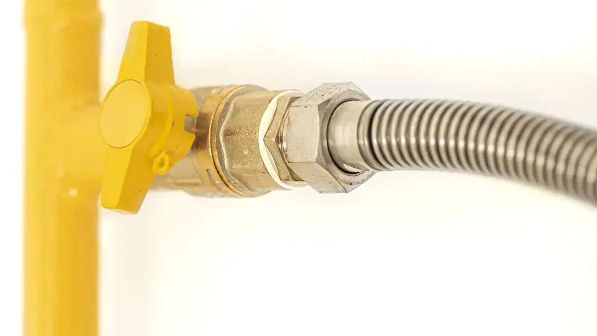 Gas pipe with a yellow-handled isolation valve