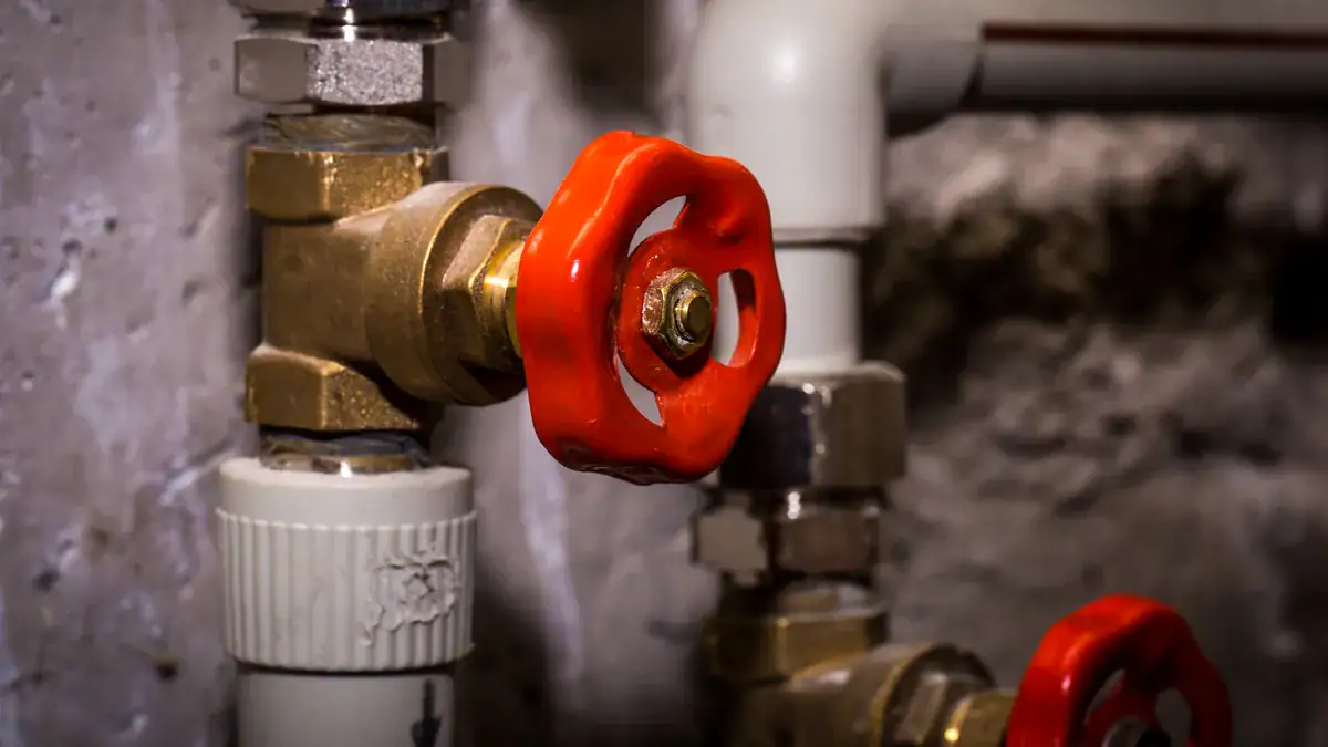 Red-handled valves on household water pipes
