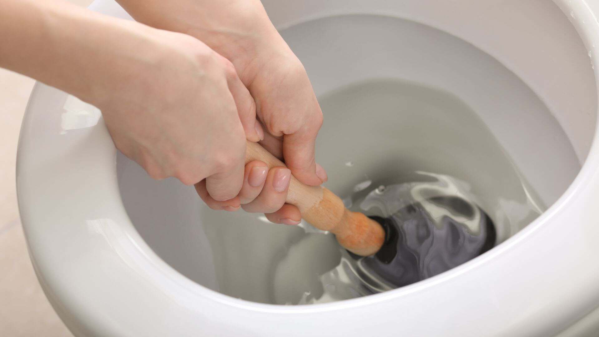 plunger-being-used-to-unblock-a-toilet