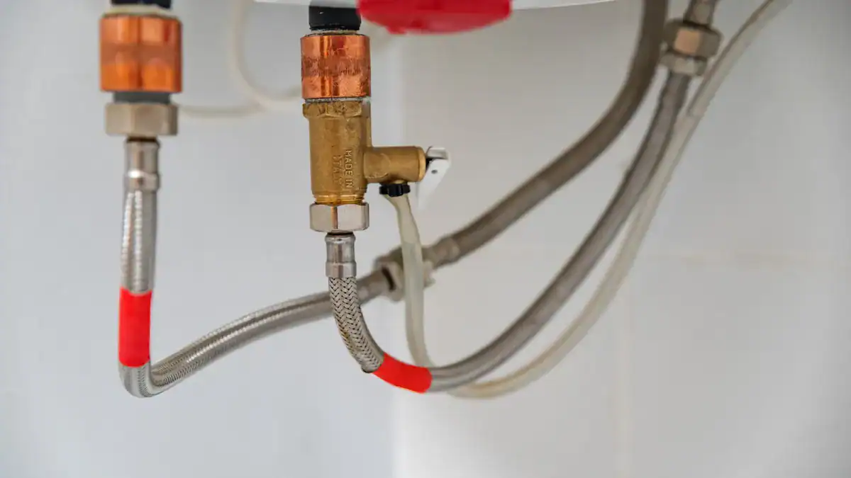 Valves and flexible water connections underneath a hot water tank